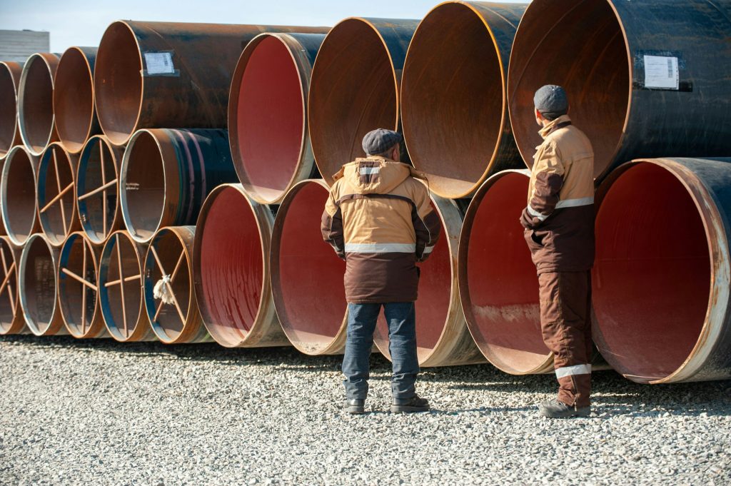 Line of oilfield large streel pipes in industrial construction area
